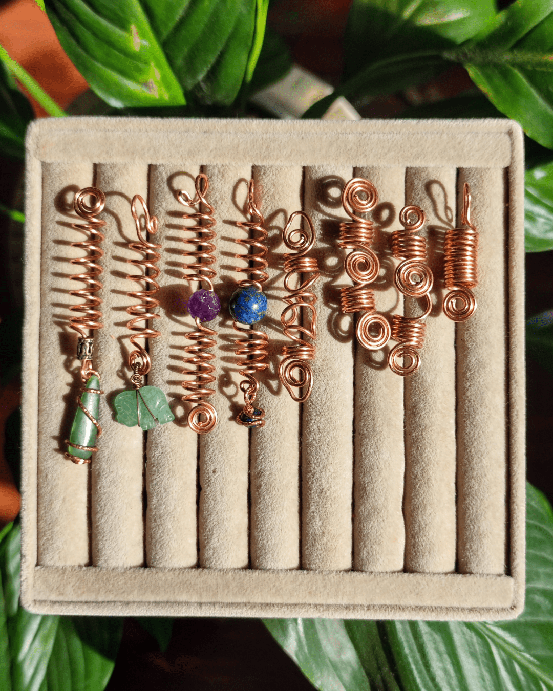 Adorn your Crown with Magic. Handmade copper loc coils with natural crystals, crafted in Lebanon. Find your unique hair jewelry at Sacred.