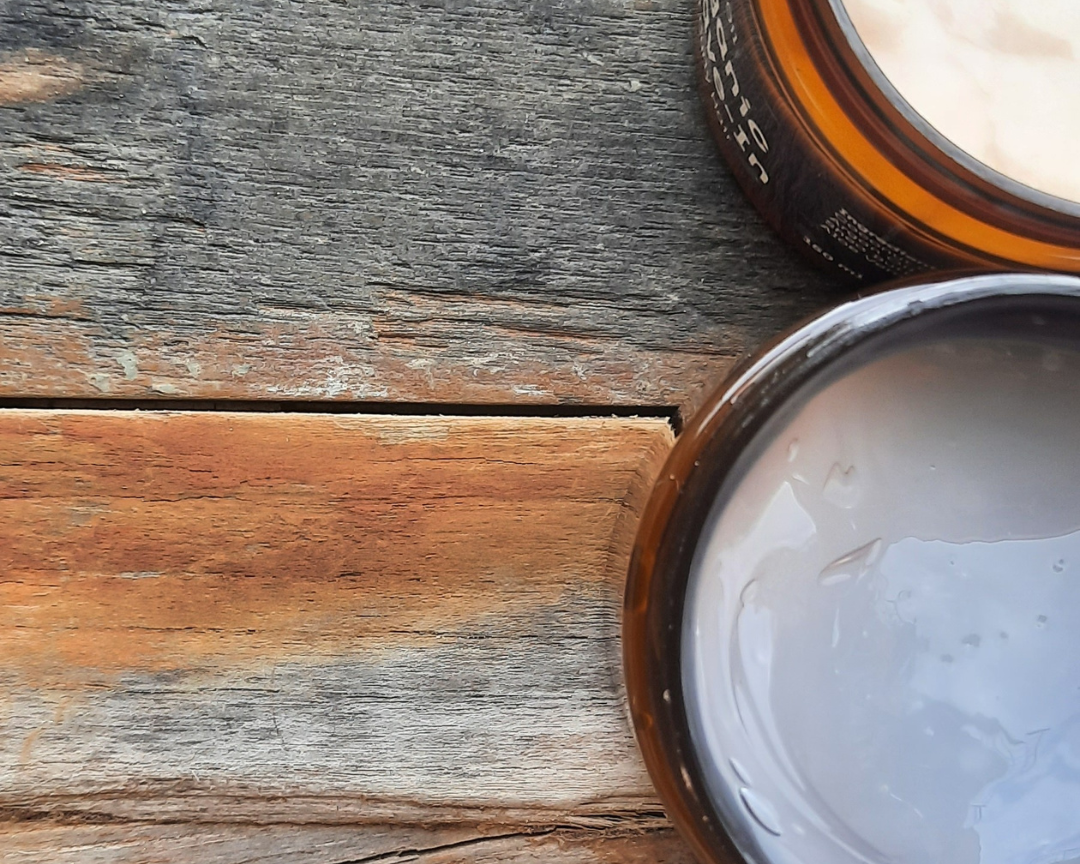 Two open jars of cream on a wooden surface. Curly Hair Organic Products - Lebanon - Glowrious