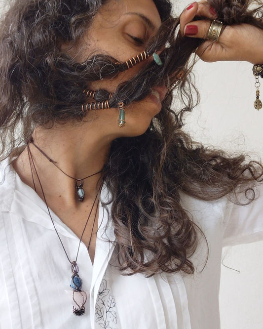 Adorn your Crown with Magic. Handmade copper loc coils with natural crystals, crafted in Lebanon. Find your unique hair jewelry at Sacred.