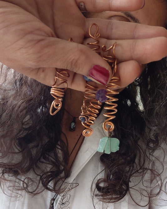 Adorn your Crown with Magic. Handmade copper loc coils with natural crystals, crafted in Lebanon. Find your unique hair jewelry at Sacred.