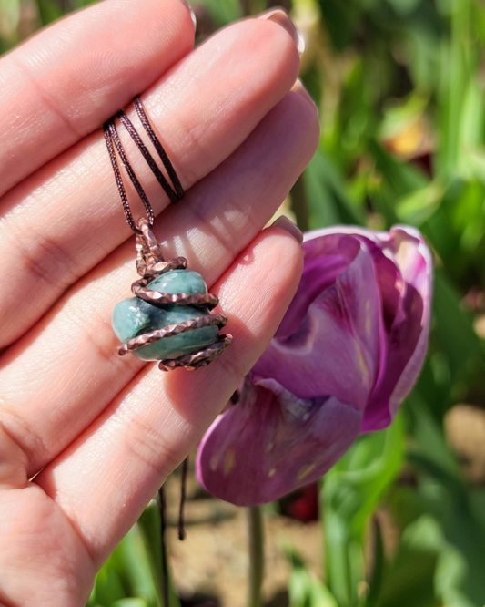 Invite Wealth with Nature's Heart. Invest in our Tumbled Emerald Pendant from our Handcrafted & Energy Cleansing Jewelry Collection at Sacred in Lebanon.