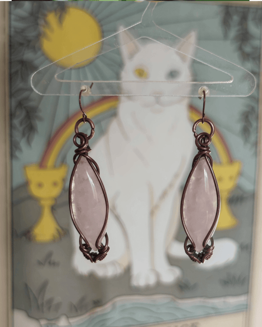 Channel emotional balance and elegance. Invest in our Double Point Rose Quartz Copper Dangle Earrings from our Energy Jewelry at Sacred in Lebanon.