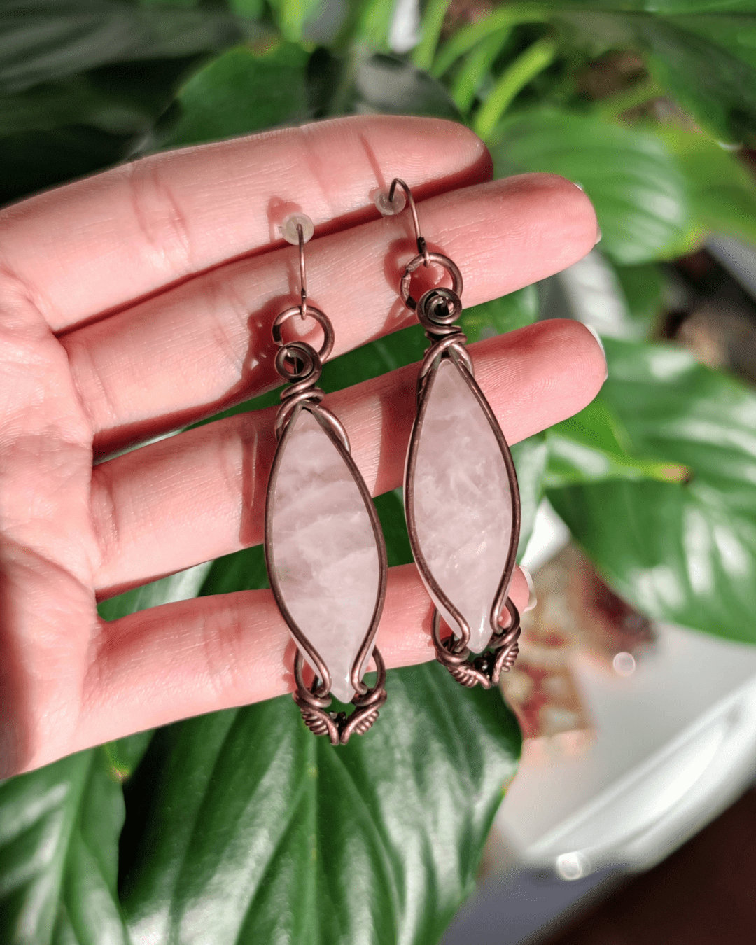 Channel emotional balance and elegance. Invest in our Double Point Rose Quartz Copper Dangle Earrings from our Energy Jewelry at Sacred in Lebanon.