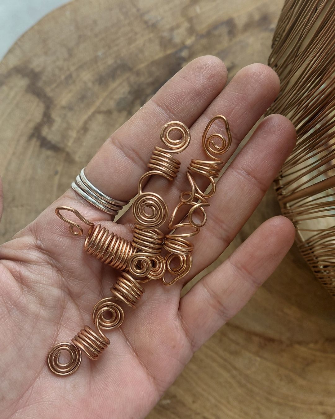 Extend your self-expression. Sleek, minimalist copper loc coils designed to embrace natural texture. Earthy hair jewelry, handmade in Lebanon at Sacred.