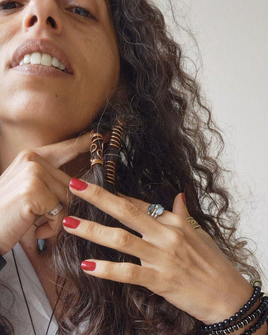 Extend your self-expression. Sleek, minimalist copper loc coils designed to embrace natural texture. Earthy hair jewelry, handmade in Lebanon at Sacred.